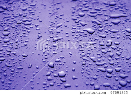 Raindrops on the hood of a car 97691825