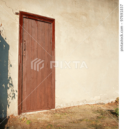 Old wooden door to a vintage dwelling Old wooden door to a vintage dwelling 97691837