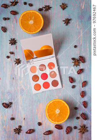 fashion summer eye palettes with fruit and spises at blue wooden background. close up fashion summer eye palettes with fruit and spises at blue wooden background. close up 97692467