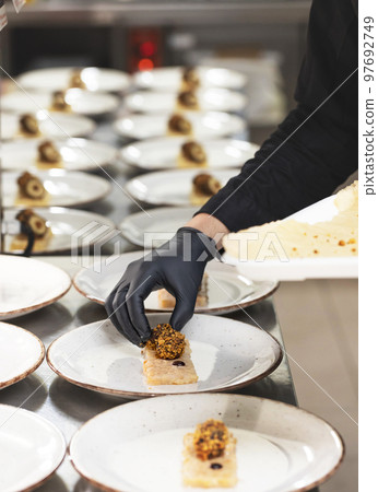 Chef preparing starter dishes Chef preparing starter dishes 97692749