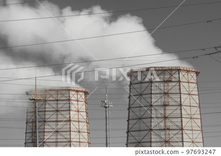 Toxic grey smoke is released from the cooling tower into the atmosphere and pollutes the environment, air and atmosphere. Operation of the industrial heat and power plant Toxic grey smoke is released from the cooling tower into the atmosphere and pollutes the environment, air and atmosphere. Operation of the industrial heat and power plant 97693247