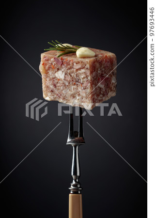 Headcheese on a fork. 97693446