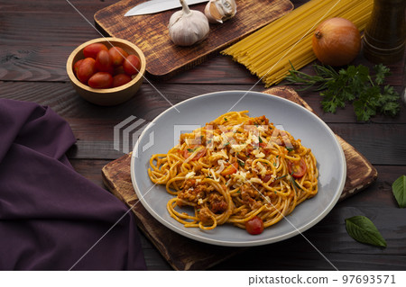 Spaghetti with minced pork in tomato sauce, pasta with a meat based bolognese tomatoes,served on gray plate 97693571