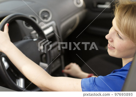 Smiling young woman-driver Smiling young woman-driver 97693893