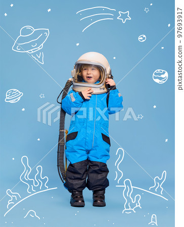 Creative design with drawn elements. Portrait of little boy, child in costume of astronaut over blue background. Funny game Creative design with drawn elements. Portrait of little boy, child in costume of astronaut over blue background. Funny game 97693917