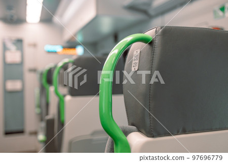Image with the interior of a german border train. A modern train with comfortable and colorful chairs. Image with the interior of a german border train. A modern train with comfortable and colorful chairs. 97696779