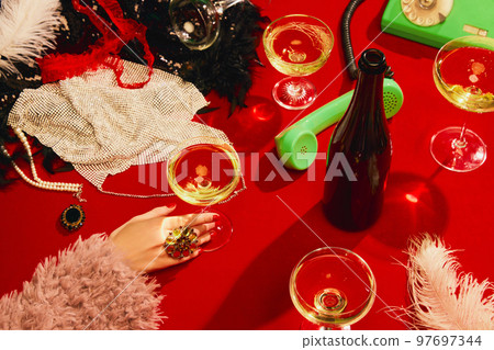 Christmas party aesthetics. Table with red tablecloths served with champagne. New year celebration 97697344