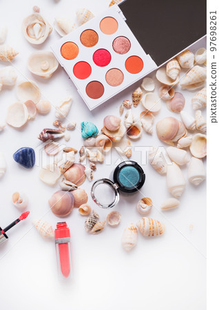 fashion summer coral eye palettes with natural shells and gemstones around background. close up fashion summer coral eye palettes with natural shells and gemstones around background. close up 97698261