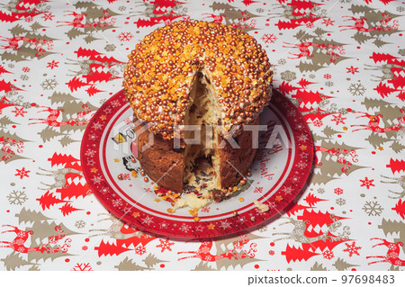 Top view of a traditional Christmas panettone cake cut on a plate. Top view of a traditional Christmas panettone cake cut on a plate. 97698483