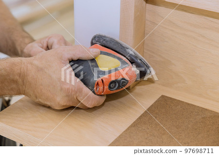 Grinding handrails with using polishing machine refinishing stairwell railings trim in new house 97698711