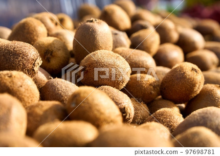 A close-up of kiwi fruit for sale at market. 97698781