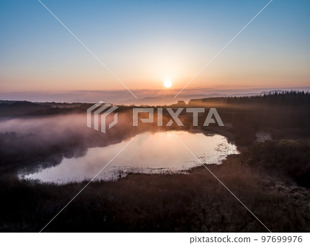 Beautiful sunrise above Peatbog in County Donegal with fog - Ireland 97699976