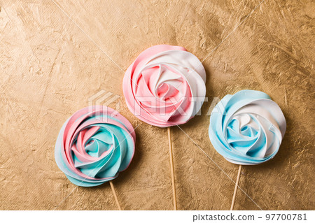A colored vegetarian aquafaba meringue candy on a stick 97700781