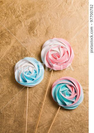 A colored vegetarian meringue candy on a stick 97700782