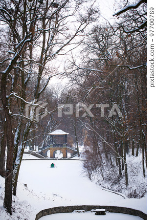 snow-covered Chinese bridge and lake in Oleksandria Park, Ukraine 97700789
