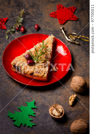 A piece of grated nut cake in a Christmas decoration 97700811