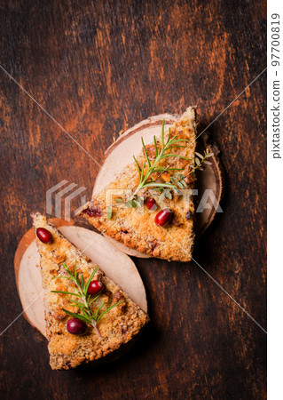 Two pieces of grated pie on wooden plates 97700819