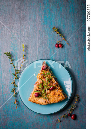 homemade grated pie with cranberries and walnuts on a blue homemade grated pie with cranberries and walnuts on a blue 97700823