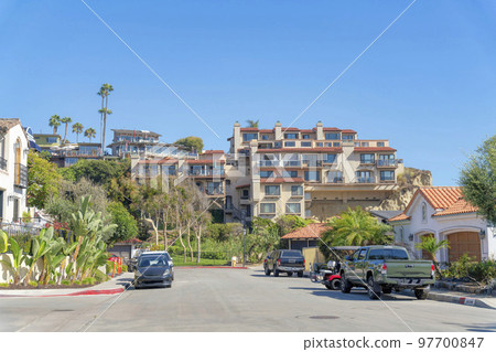 Street in a residential area with parked vehicles on the side at San Clemente, California Street in a residential area with parked vehicles on the side at San Clemente, California 97700847