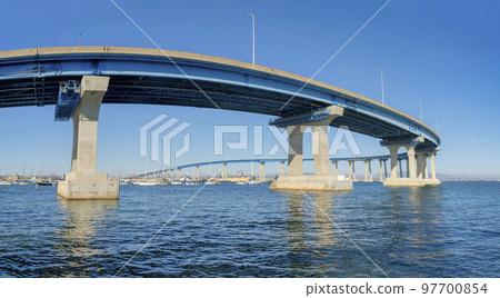 Curved bridge over the water in Coronado, San Diego, California 97700854