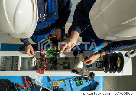 Electricians test motherboard in special equipped laboratory 97700966