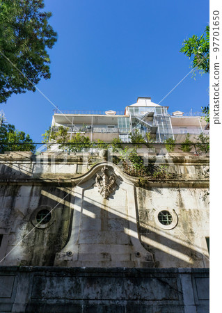 Ancient fountain with a coat of arms in the historic centre of Lisbon 97701650