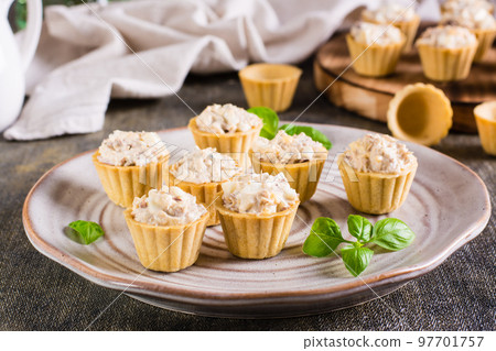 Tartlets with canned fish salad, eggs and mayonnaise on a plate. Homemade snacks Tartlets with canned fish salad, eggs and mayonnaise on a plate. Homemade snacks 97701757