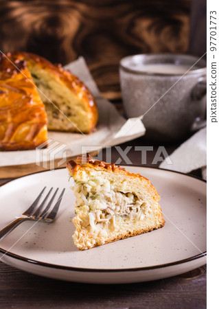 Traditional savory pie kurnik with chicken, potatoes and rice. Homemade  baking. Vertical view Stock Photo