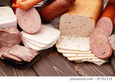 Variety of meat and sausage products on table 97702114