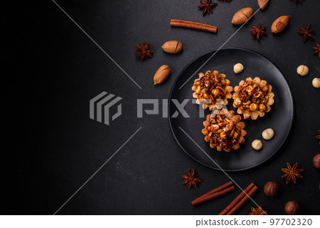 Sweet tasty tart with nuts and honey on a dark concrete background 97702320