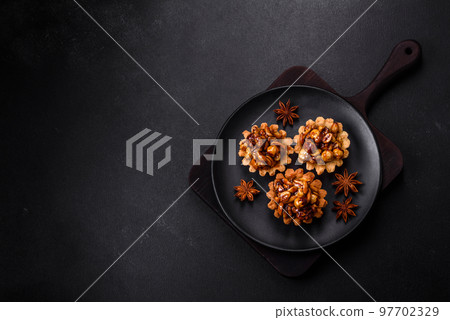 Sweet tasty tart with nuts and honey on a dark concrete background 97702329