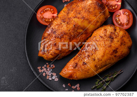 Delicious grilled chicken fillet with spices and herbs Delicious grilled chicken fillet with spices and herbs 97702387