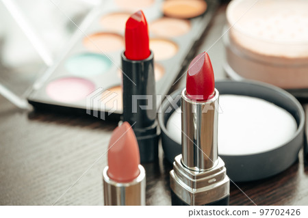 Pink and red lipsticks on vanity table Pink and red lipsticks on vanity table 97702426
