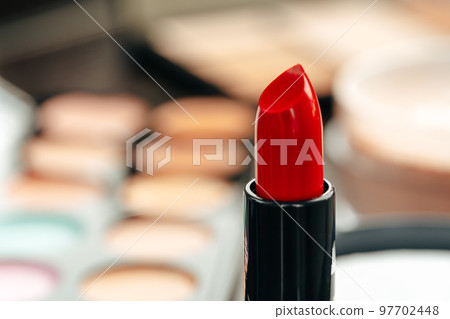 New red lipstick on vanity table close up New red lipstick on vanity table close up 97702448