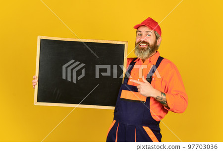 Conference Meeting. person presenting at chalkboard. Businessman. male construction worker. man with presentation. Builder points to board. Successful Architect Worker hold blackboard. copy space Conference Meeting. person presenting at chalkboard. Businessman. male construction worker. man with presentation. Builder points to board. Successful Architect Worker hold blackboard. copy space 97703036