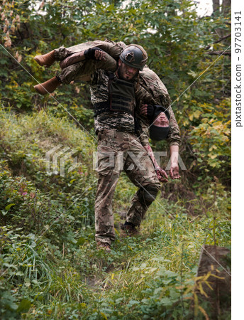 The commander carries a wounded soldier 97703141