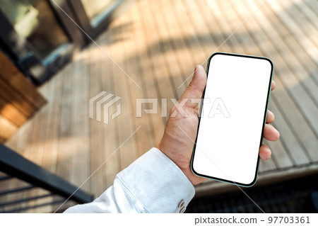 Smart home app template with blank white smartphone screen in male hand against the modern house. 97703361