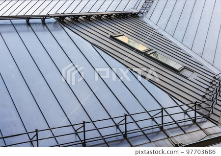Shiny metal roof with railings and attic windows, modern architecture 97703686