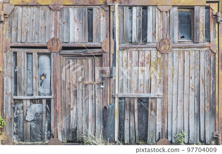 old rotten wooden gate in abandoned factory 97704009