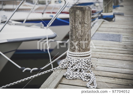Wooden post for mooring yachts on the pier in Denmark Wooden post for mooring yachts on the pier in Denmark 97704052