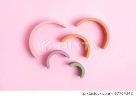 Education kid arch toy , pastel pyramid game on pink background. Colorful wooden figure on yellow background, kid play concept 97704348