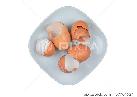 Eggshell. Shell of eggs in a plate on isolated on white background. Organic waste for compost. Eggshell. Shell of eggs in a plate on isolated on white background. Organic waste for compost. 97704524