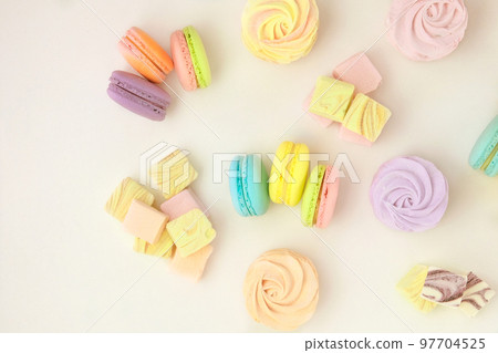 Various of sweets: macaroons, marshmallows and zephyrs. Delicate colored desserts for the holiday. Top view. Copy space. Various of sweets: macaroons, marshmallows and zephyrs. Delicate colored desserts for the holiday. Top view. Copy space. 97704525