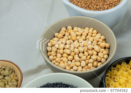 Yellow chickpeas in bowl. Various vegetarian organic products. Vintage view. Yellow chickpeas in bowl. Various vegetarian organic products. Vintage view. 97704562