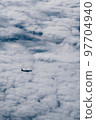 Airplane in the sky in the clouds, vertical photo 97704940