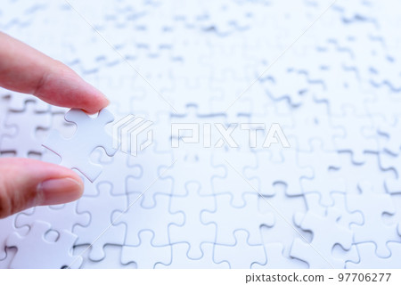 Scattered jigsaw puzzle background texture Hand holding one piece Strategy Bright and cool color Scattered jigsaw puzzle background texture Hand holding one piece Strategy Bright and cool color 97706277