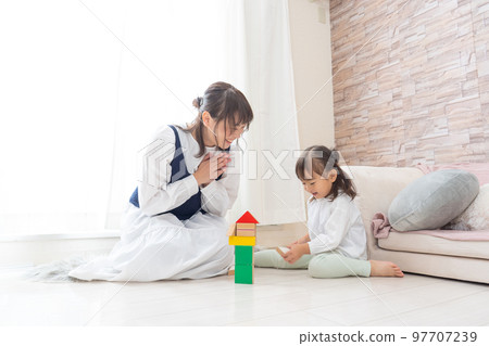 Infants playing with toys Infants playing with toys 97707239