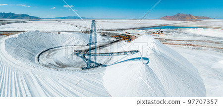 Salt Lake City, Utah landscape with desert salt mining factory at lake Bonneville with piles of white mineral and industrial equipment 97707357