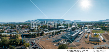 Panoramic aerial view of the city of Reno cityscape in Nevada. Downtown Reno, Nevada, with hotels, casinos and the surrounding High Eastern Sierra foothills. Panoramic aerial view of the city of Reno cityscape in Nevada. Downtown Reno, Nevada, with hotels, casinos and the surrounding High Eastern Sierra foothills. 97707406