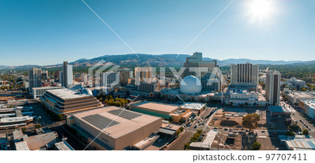 Panoramic aerial view of the city of Reno cityscape in Nevada. Downtown Reno, Nevada, with hotels, casinos and the surrounding High Eastern Sierra foothills. Panoramic aerial view of the city of Reno cityscape in Nevada. Downtown Reno, Nevada, with hotels, casinos and the surrounding High Eastern Sierra foothills. 97707411